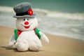 Snowman toy on the beach Royalty Free Stock Photo