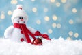 Snowman toy and ball on snow against blurred festive lights, closeup. Space for text Royalty Free Stock Photo