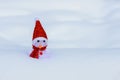 Snowman toy in a coffin in winter, snowman dressed as santa claus in a red hat and scarf in the snow, christmas card