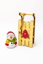 Snowman toy and wooden sled isolated on white background Royalty Free Stock Photo