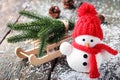 Snowman toy and wooden sleigh Royalty Free Stock Photo