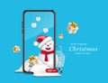 A snowman wearing a Santa hat and smiling behind his smartphone Royalty Free Stock Photo