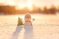 Snowman in winter wonderland scene. Christmas, New Year postcard design. Wintertime magic. Snowman in december snow at sunset Royalty Free Stock Photo