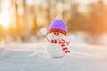 Snowman in winter wonderland scene. Christmas, New Year postcard design. Wintertime magic. Snowman in december snow at sunset Royalty Free Stock Photo