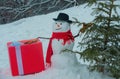 Snowman Woodcutter with axe in the winter forest. SnowMan is going to cut a christmas tree. Snowman with axe is carrying Royalty Free Stock Photo