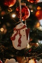 Snowman wooden Christmas tree decorations and lights close up