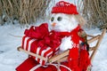 Snowman In A Wooden Sled With Christmas Gift Royalty Free Stock Photo