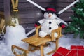 Snowman on a wooden sleigh