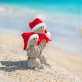 Snowmans couple at sea beach in christmas hat. New years holiday Royalty Free Stock Photo