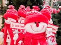 Snowmen are sold on the counters near the Christmas trees in the shopping center, dressed in a red cap and with a sign with