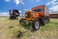 A snowmobile from a bygone age, complete with tracks and skis, rests on the prairie.