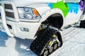 Snowmobile with caterpillars of triangular shape. A closeup of a snowmobile machine on snow in the mountains. Goose