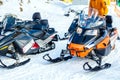 Snowmobile. Close-up of row of snowmobiles stand in snow, view from below, skiing.