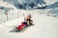 Snowmobile machine with sled and equipment riding fast hurry up driver to help injured skier or snowboarder at accident on winter