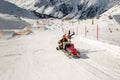 Snowmobile machine with sled and equipment riding fast hurry up driver to help injured skier or snowboarder at accident on winter