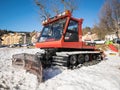 Snowmobile parked at the end of a ski slope. Royalty Free Stock Photo