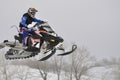 Snowmobile racer flying down the mountain