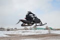 Snowmobile rider flying high air