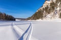 Snowmobile track on frozen mountain river Royalty Free Stock Photo