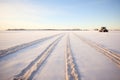 snowmobile tracks across a snowy open field Royalty Free Stock Photo