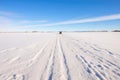 snowmobile tracks across a snowy open field Royalty Free Stock Photo