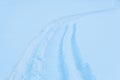 Snowmobile tracks in deep snow. Twisting traces of a snowmobile crossing snow field Royalty Free Stock Photo