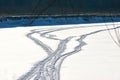 Snowmobile tracks on the frozen river