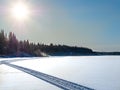 Snowmobile trail on frozen lake