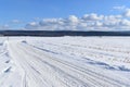 A snowmobile trail under a blue sky Royalty Free Stock Photo