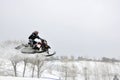 Snowmobile unidentified rider airborne