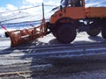 Snowplough shovel machin cleaning the road from snow and ice in winter