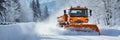 A snowplough working to remove snow from a road after a winter storm. Winter road clearing