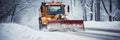 A snowplough working to remove snow from a road after a winter storm. Winter road clearing