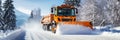 A snowplough working to remove snow from a road after a winter storm. Winter road clearing