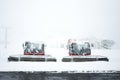 Snowploughs machinery plowing snow on ground in Tyrol, Austria