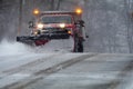 Snowplow in action clearing residential roads during snow storm Royalty Free Stock Photo