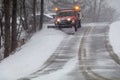Snowplow in action clearing residential roads during snow storm Royalty Free Stock Photo