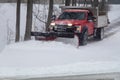 Snowplow in action clearing residential roads during snow storm Royalty Free Stock Photo