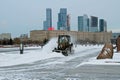 Snowplow cleans from the road snow in Victory park in Moscow Royalty Free Stock Photo