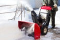 A snowplow clears the road to the plot