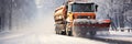 A snowplow removes snow from the road during a winter snowstorm.