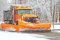 Snowplow in snowstorm removing snow off roads