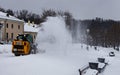 a snowplow tractor rides the park alley