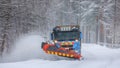 Snowplow truck clearing a snow-covered icy road Royalty Free Stock Photo