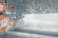 Snowplow truck removing dirty snow from city street or highway after heavy snowfalls. Traffic road situation. Weather forecast for Royalty Free Stock Photo