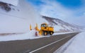 Snowplow truck Snow removal truck is removing the snow from the highway during a cold snowstorm winter day.