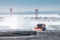 Snowplow trucks clear snowdrifts after heavy storm blizzard at winter airport. The concept of changing weather conditions and