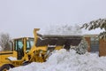 Snowplow trucks remove snow from a parking lot after heavy snowfalls