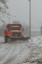 Snowplow trucks removing snow on the road street during blizzard snowstorm in NY