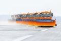 Snowplows in the work on the runway at the airport.